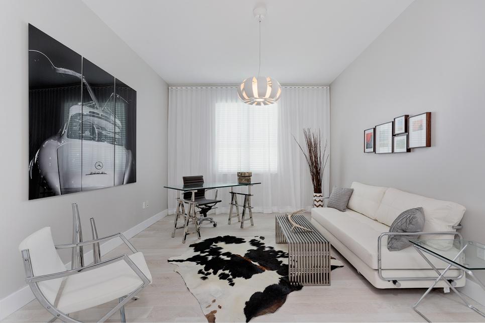 Monochromatic White Modern Living Room With Animal Hide Rug, Triple Panel  Wall Art, and Leather Furniture | HGTV