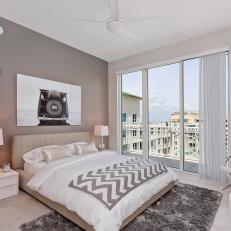 Cool Tone Modern Bedroom With Chevron Throw Blanket, Gray Shag Rug and Sliding Glass Balcony Door 