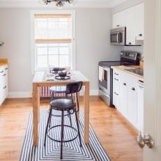 Airy, Contemporary Eat In Kitchen With Gray and White Graphic Rug and Tall Natural Wood Kitchen Over Hardwood Floor 