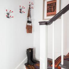 Gray Steps With Southwestern Striped Runner, Mounted Hooks With Orange Knobs and Bold Type Photo 