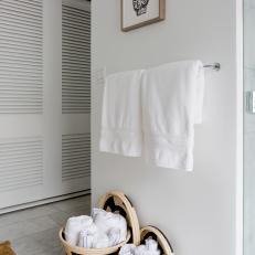 Contemporary Bathroom With Basket Towel Storage and Sign Language Wall Art 