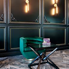 Captivating Art Deco Sitting Space With Black Wall Panelling, Green Velvet Chair and Prism Coffee Table 