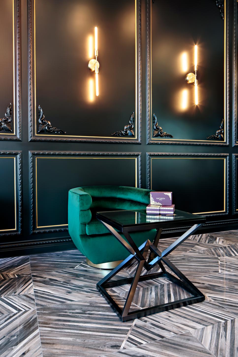 Captivating Art Deco Sitting Space With Black Wall Panelling Green Velvet Chair And Prism Coffee Table Hgtv