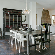Unique Contemporary Dining Room With Large Asian Cabinet, Tall End Chairs and Dark Stone Floor 