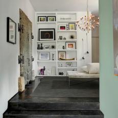 Contemporary Hallway With Artsy Shelf Display, Antique Double Doors and Black Stone Flooring 