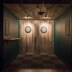 Dim Dart Entertainment Area With Spotlights on Two Dart Boards, Dark Green Walls and Checked Floor