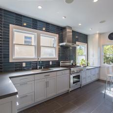 Contemporary Eat-In Kitchen With Navy Blue Tile Accent Wall