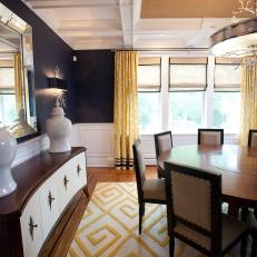 Navy Blue Dining Room With Midcentury Buffet and Yellow Rug