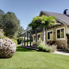 Cottage Front Yard With Pergola And Spherical Wooden Yard Art
