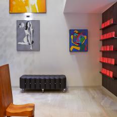 Modern Sitting Space with Bold, Colorful Art Prints, Black Leather Bench and Minimalist Wood Chair 