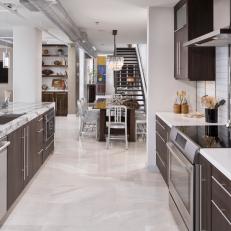Contemporary Kitchen Featuring Bold Marble Island Countertop, Sleek Finishes and Connected Dining Room 