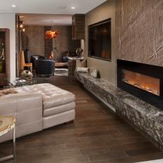 Contemporary Living Room With Stone Fireplace Surround and Bench and Tufted Leather Sectional 