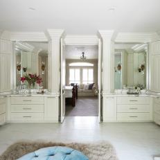 Spacious Double Vanity Master Bathroom With Built In Cream Cabinets, White Marble Floor and Large Vanity MIrrors 
