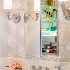 Neutral Foral Wallpaper Behind Medicine Cabinet Mirror and Mounted Sconces over Marble Bathroom Vanity Countertop 