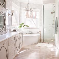 Chevron Hardwood Floor, White Bathtub and Glass Door Shower in Bright Contemporary Bathroom 