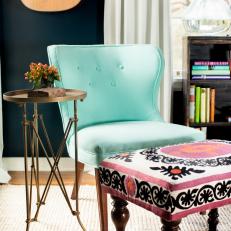 Blue Chair and Pink and Black Ottomans Create a Warm and Inviting Feel