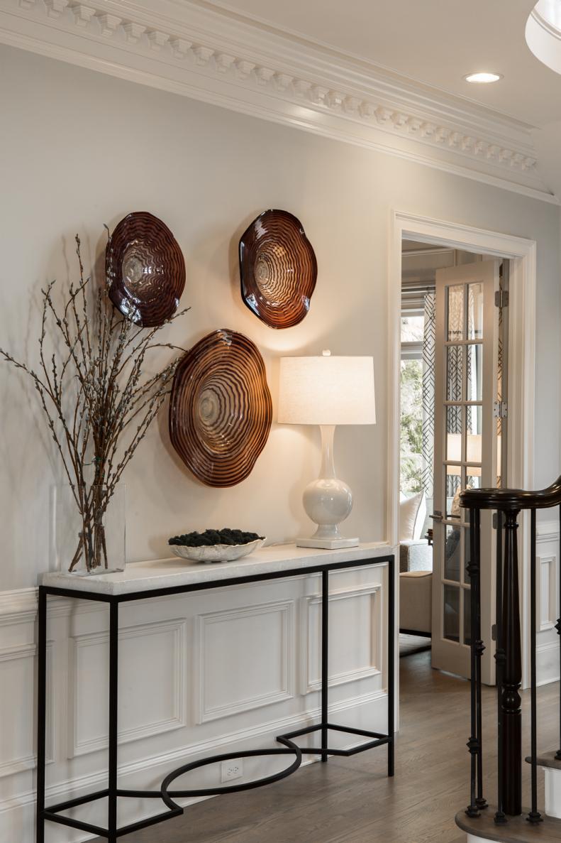 Transitional Entry With Black & White Table, Brown Glass Art