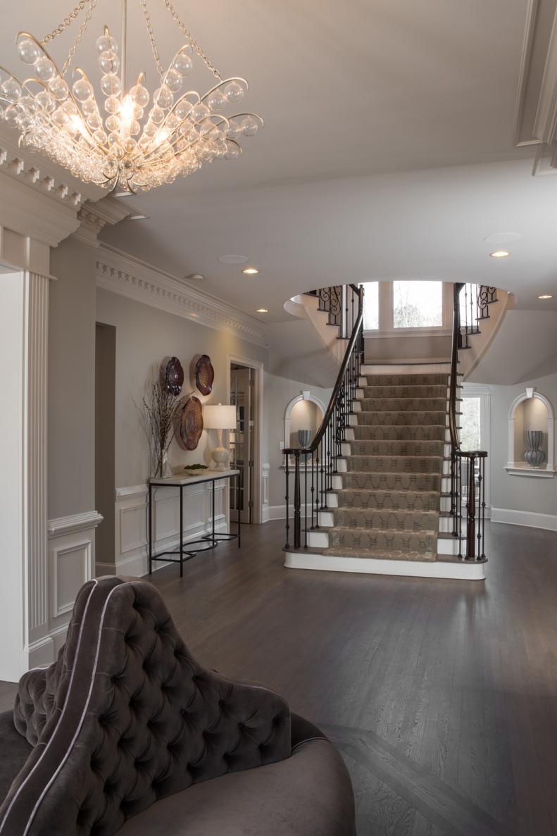 Transitional Entryway With Gray Tufted Settee & Staircase