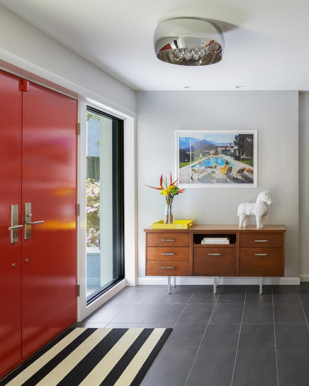 Midcentury Modern Foyer With Red Front Doors, Wood Table & Striped Rug