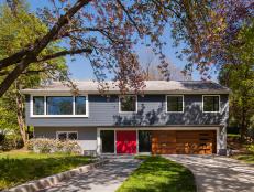 Midcentury Modern Exterior With Blue Siding & Red Front Doors
