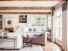 White Transitional Living Room With Exposed Ceiling Beams