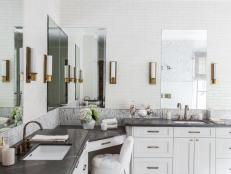 Black and White Master Bathroom With Brass Sconces