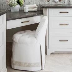 Gray and White Bathroom Vanity and White Chair