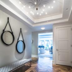 Foyer With Hardwood Flooring and Unique Chandelier
