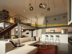 Urban Loft With White Sectional and Hanging Lights