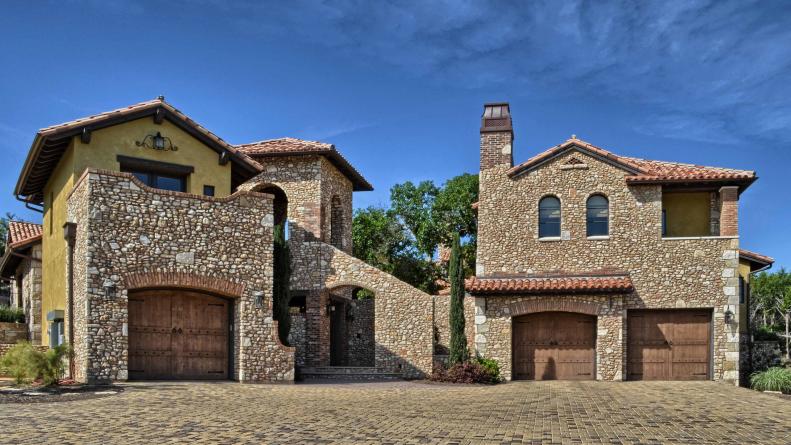 Mediterranean Stone Exterior With Paver Driveway