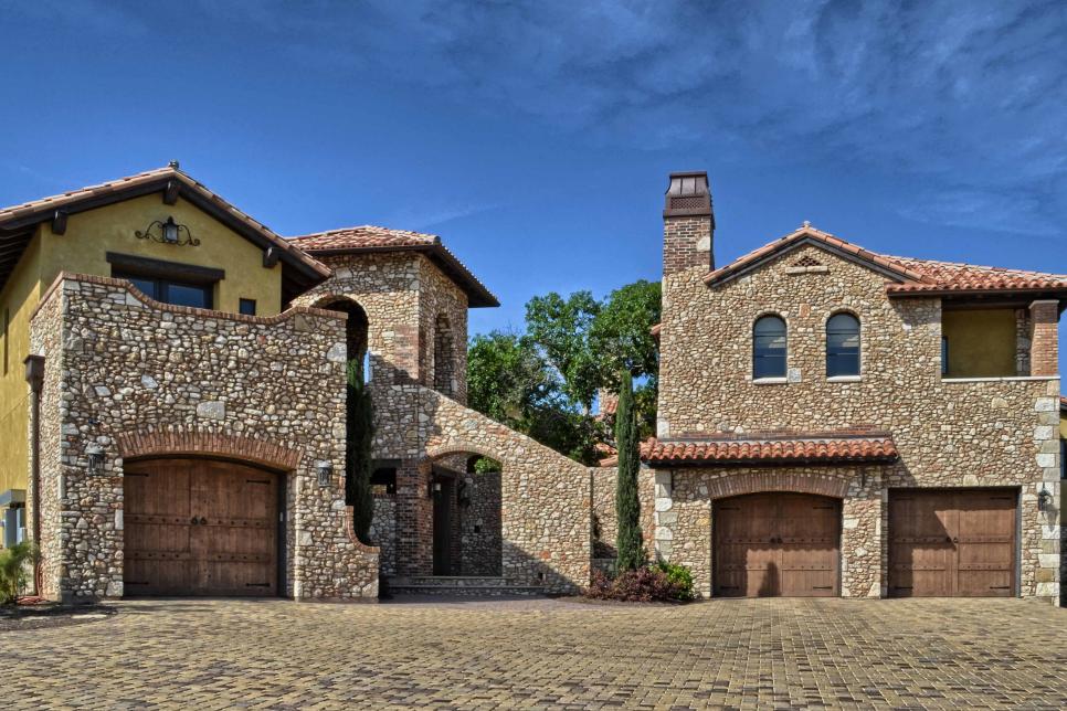Mediterranean Stone Exterior With Paver Driveway