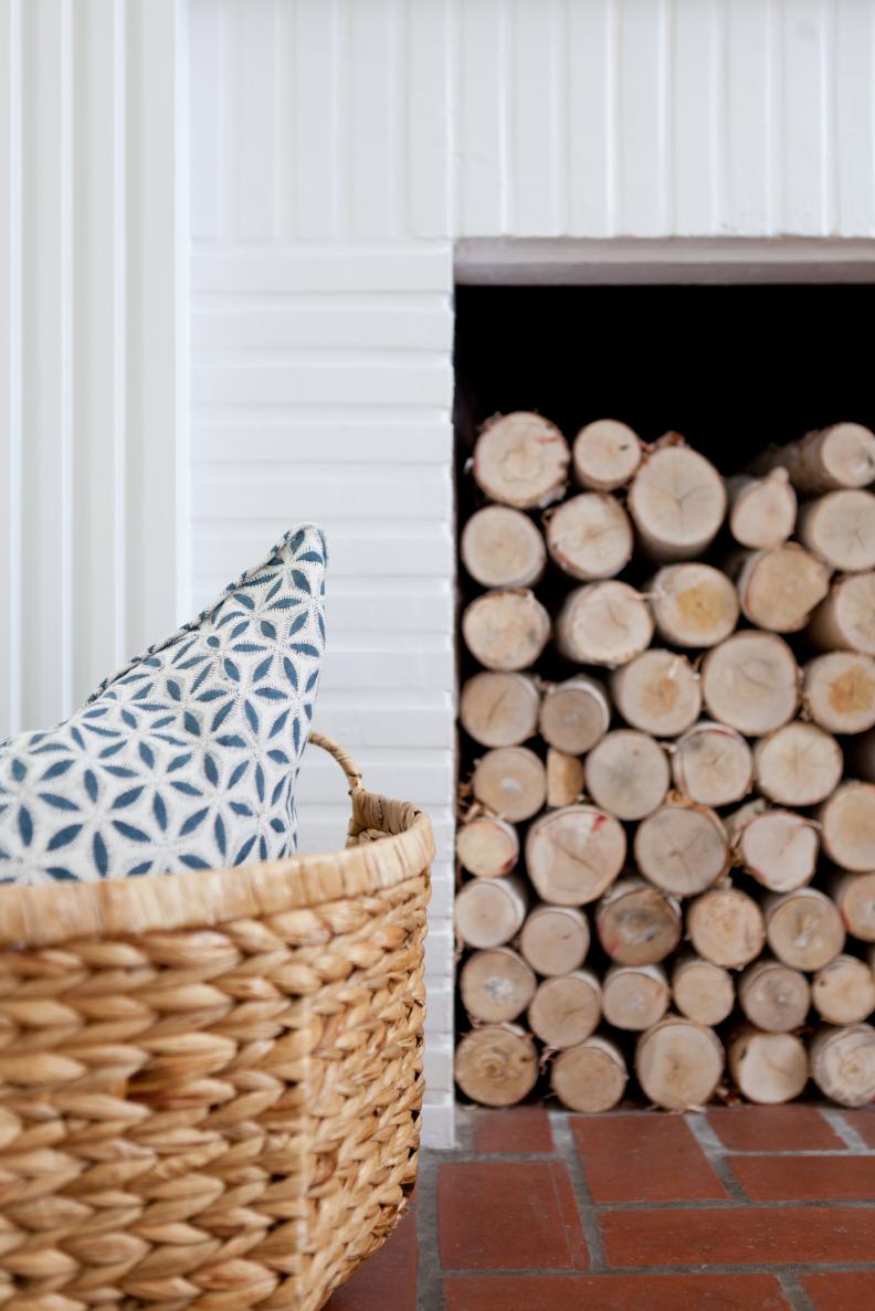 Stacked Wood Logs and Basket With Pillow