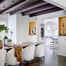Fresh, White Dining Room With Exposed Beam Ceiling