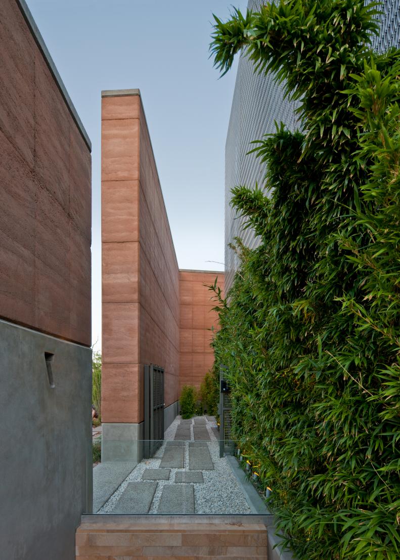 Modern Stone and Gravel Pathway With Green Garden Wall