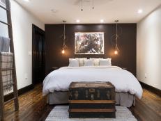 Neutral Eclectic Bedroom With Brown Accent Wall, Ladder and Trunk