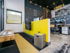 Contemporary Public Space With Yellow Half Wall and Concrete Floor