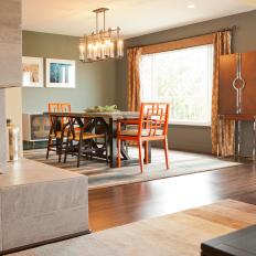 Brown Contemporary Dining Area With Orange Chairs