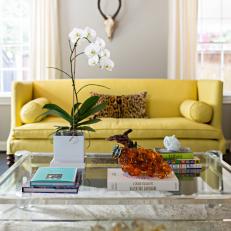 Family Room With Lucite Coffee Table & Cheery Yellow Sofa