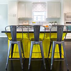 Bright, Yellow Kitchen Island With Metal Barstools