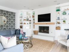 Coastal Living Room With Seashell Wallpaper and Built-In Bookcases