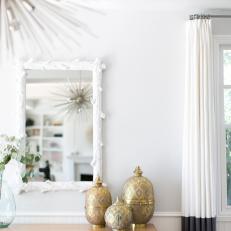 Living Room Console Table Decorated With Gold Urns