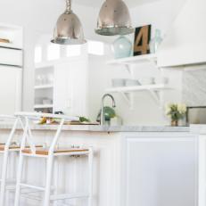 Pair of Large Silver Pendant Lights Over White Kitchen Island