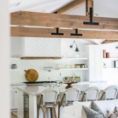 Wood Exposed Ceiling Beams, Large White Island With Marble Countertop and White Brick Wall in Gorgeous Country Kitchen 