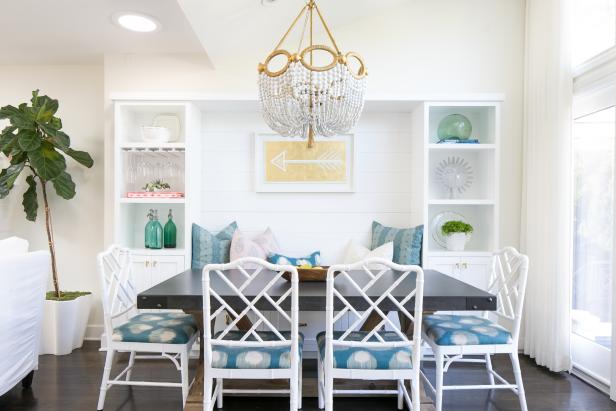 Coastal Dining Room With Dark Wood Table White Chairs With Patterned Blue Cushions And Bench Seat With Surrounding Shelves Hgtv