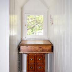Transitional Hallway Features Antique Writing Desk