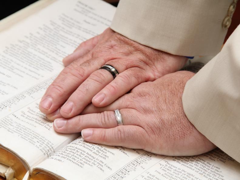 Two Men's Hands Wearing Wedding Bands