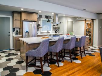 As seen on America’s Most Desperate Kitchens, this renovated Sacramento, California kitchen features matching octogonal wall and floor tiles, stainless appliances and an eat in counter with upholstered stools. (After)