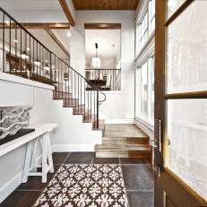 Wood Details in Transitional White Foyer With Patterned Tile Floor Panel and Open Stairs 