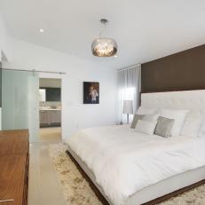 Modern Master Bedroom With Platform Bed and Circular Chandelier