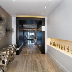 Contemporary Hall With Metallic Console Table and Figurine Display